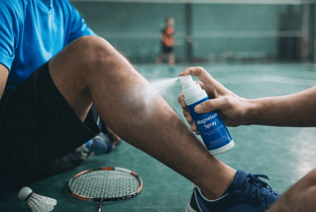 Man holding tennis racquet and deodorant bottle